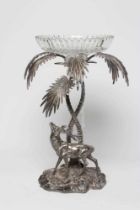 A VICTORIAN CUT GLASS AND PLATED CENTREPIECE with palm tree and deer on a rocky base, 19" high (Est.