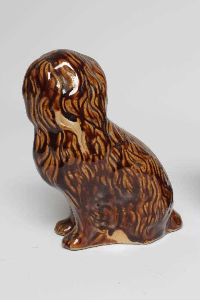 A PAIR OF EARLY VICTORIAN TREACLE GLAZED HEAVY STONEWARE SPANIELS modelled with a free standing fore - Image 3 of 4