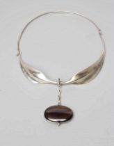 A GEORG JENSEN SILVER NECK RING designed by Viviana Torun Bulow-Hube, the tension clamp extending to