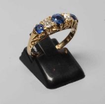 A LATE VICTORIAN SAPPHIRE AND DIAMOND FIVE STONE RING, the three graduated sapphires and two