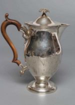 A LATE VICTORIAN SILVER HOT WATER JUG, maker Huttons, London 1900, of baluster form, the hinged