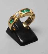 AN EMERALD AND DIAMOND HALF HOOP RING, the heavy cast panel centred by three channel cut emeralds