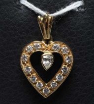 A DIAMOND HEART PENDANT, the thirteen mix cut stones point set to an open border centred by a single