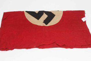 A GERMAN THIRD REICH FLAG of typical form with red ground and central swastika, one sided, 38" x