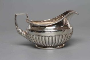 A LATE GEORGE III SILVER MILK JUG, maker Burwash and Sibley, London 1809, of semi-fluted squat