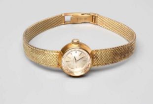 A LADY'S 14CT GOLD OMEGA WRISTWATCH, the silvered dial with gilt metal batons in a plain tapering