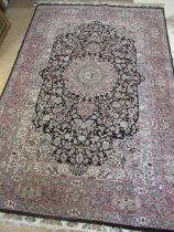 A PERSIAN RUG, the black floral field with rose pink gul and ivory spandrels within a pale blue