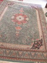 A TURKISH CARPET, modern, the pale green floral ground with central gul in pink, ivory and black