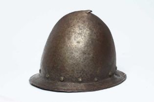 A SPANISH MORION OR CABASSET HELMET, late 16th century, of rough conical form, with hammered