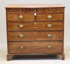A GEORGIAN MAHOGANY CHEST, c.1800, the moulded edged top over three small chequer banded frieze