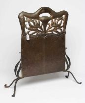 AN ARTS AND CRAFTS COPPER FIRESCREEN, of arched oblong form pierced with foliate panels, similar end