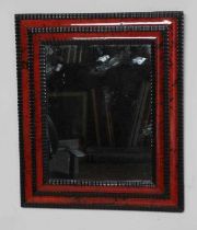 A RED TORTOISESHELL AND EBONY(?) WALL MIRROR of 17th century design, 19th century, the oblong
