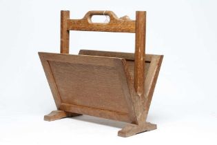A ROBERT THOMPSON OAK MAGAZINE RACK with panelled sides and loop handle, on octagonal supports and