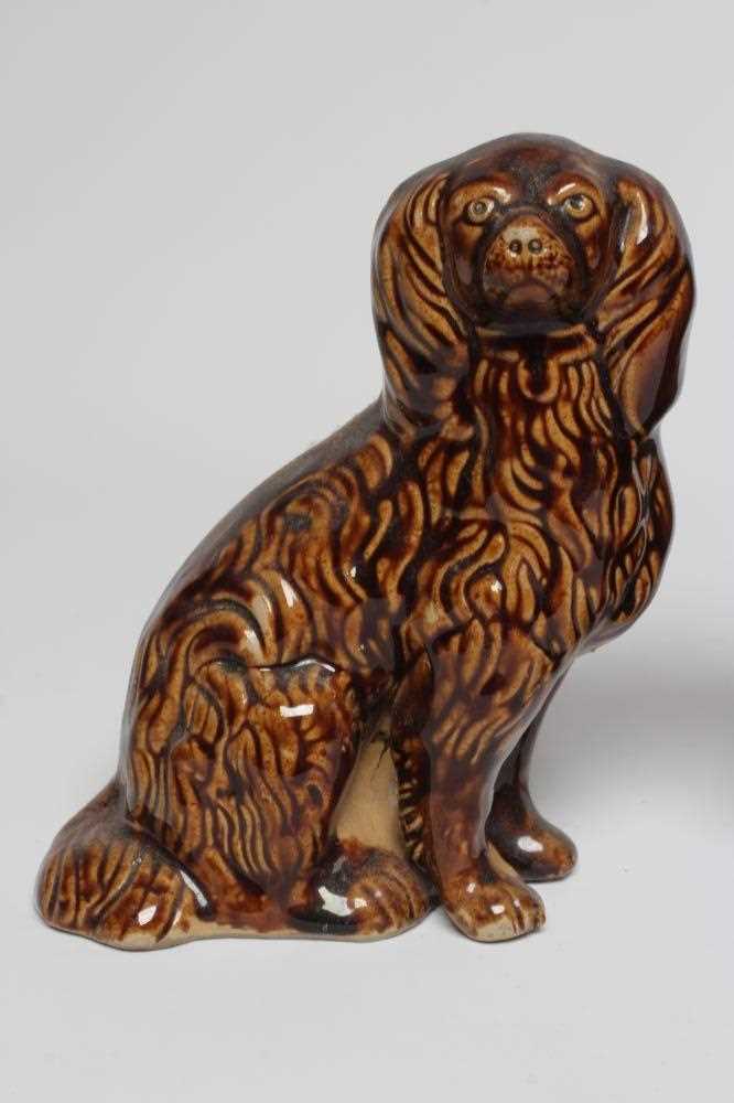 A PAIR OF EARLY VICTORIAN TREACLE GLAZED HEAVY STONEWARE SPANIELS modelled with a free standing fore - Image 2 of 4