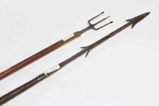 TWO TRIBAL FISHING SPEARS, one with barbed tip and original shaft with weighted wrappings, the other