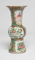 A CANTONESE PORCELAIN FAMILLE ROSE SMALL GU VASE painted with panels of figures, flowers and birds