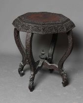 A BURMESE HARDWOOD OCCASIONAL TABLE, c.1900, of octagonal form profusely carved with scrolling