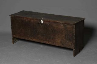 AN OAK BOARDED CHEST, mid to late 17th century, the hinged lid and fascia with incised banding and