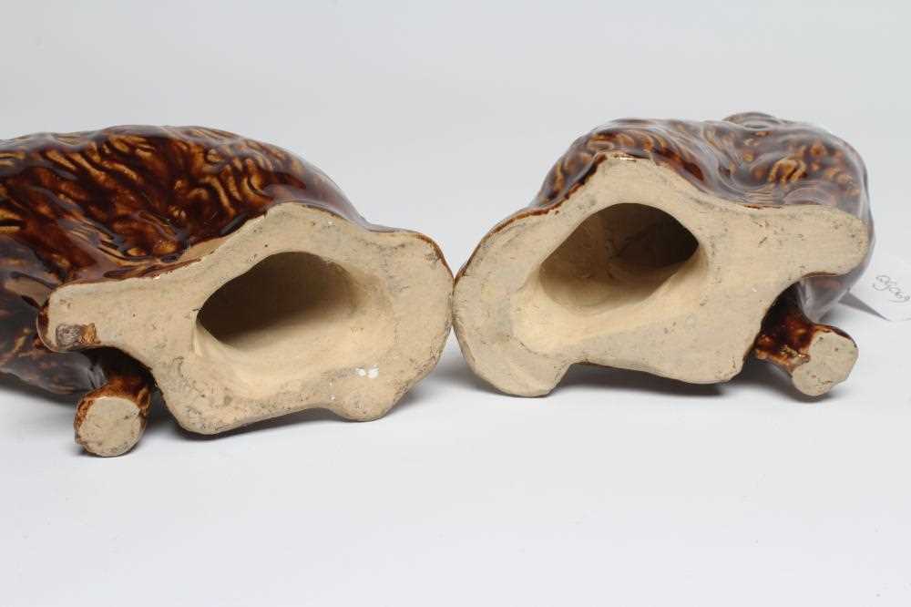 A PAIR OF EARLY VICTORIAN TREACLE GLAZED HEAVY STONEWARE SPANIELS modelled with a free standing fore - Image 4 of 4
