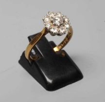 A DIAMOND CLUSTER RING, the central brilliant cut stone of approximately 0.20cts within a border