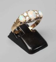 A LATE VICTORIAN OPAL AND DIAMOND RING, the three oval cabochon polished opals claw set with two