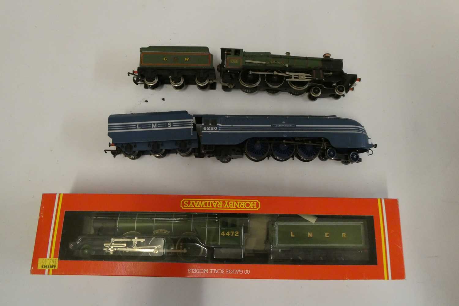 Hornby Flying Scotsman locomotive in LNER green, Coronation locomotive in LMS blue, and Wrenn
