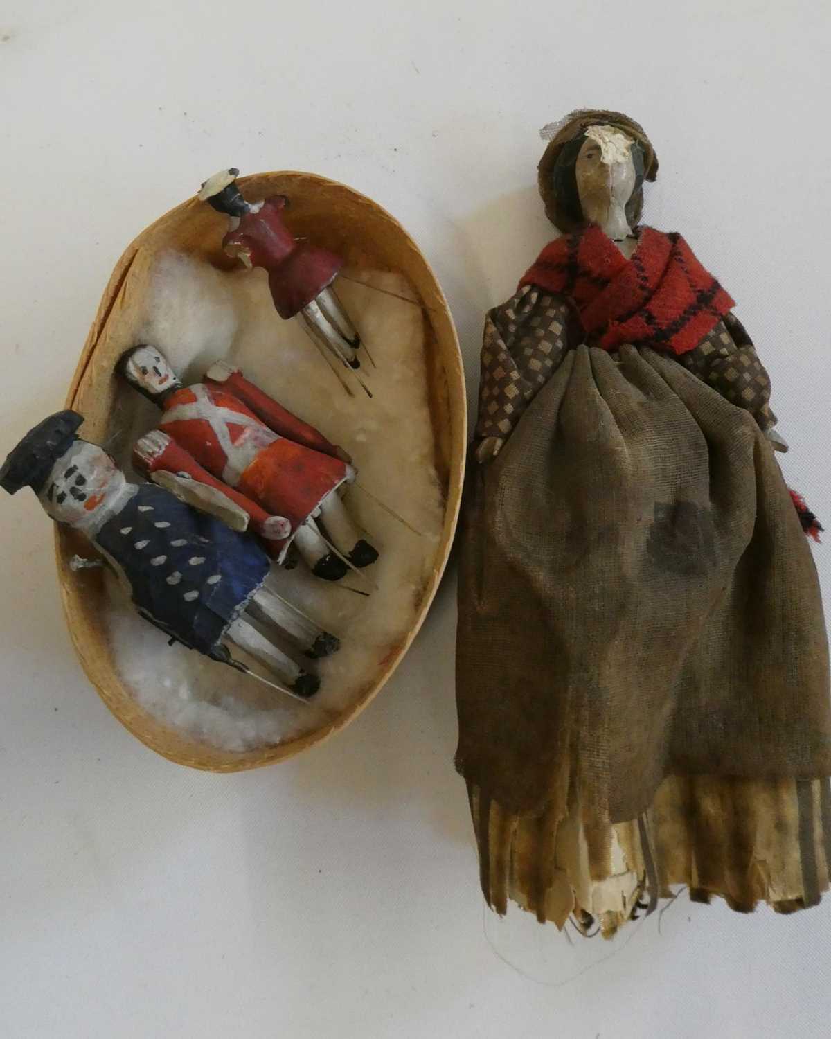 Three wooden piano dolls, c.1880, with painted features and jointed legs, largest 2 1/4" long,