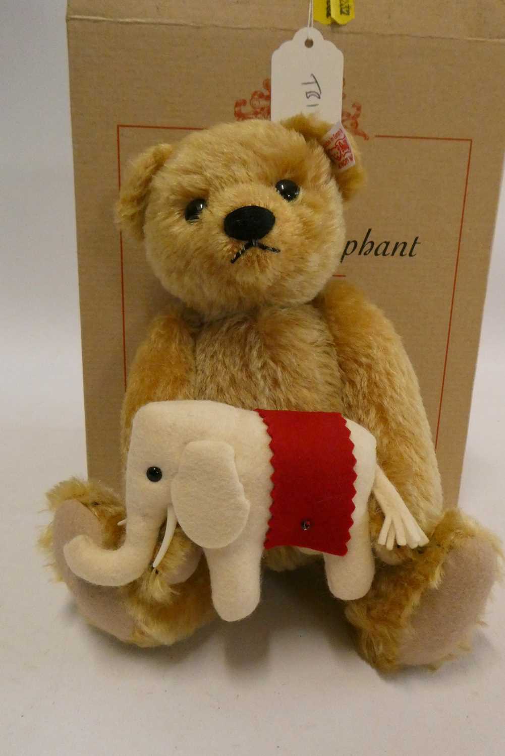 Steiff "Teddy's Elephant" bear, a 24cm bear holding a felt elephant, with ear button, label and