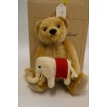 Steiff "Teddy's Elephant" bear, a 24cm bear holding a felt elephant, with ear button, label and