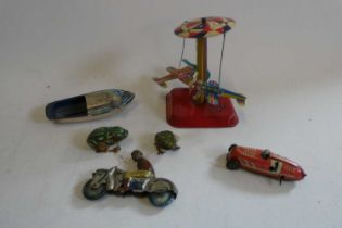 Post war tinplate toys comprising two US zone clockwork frogs, clockwork roundabout, small clockwork