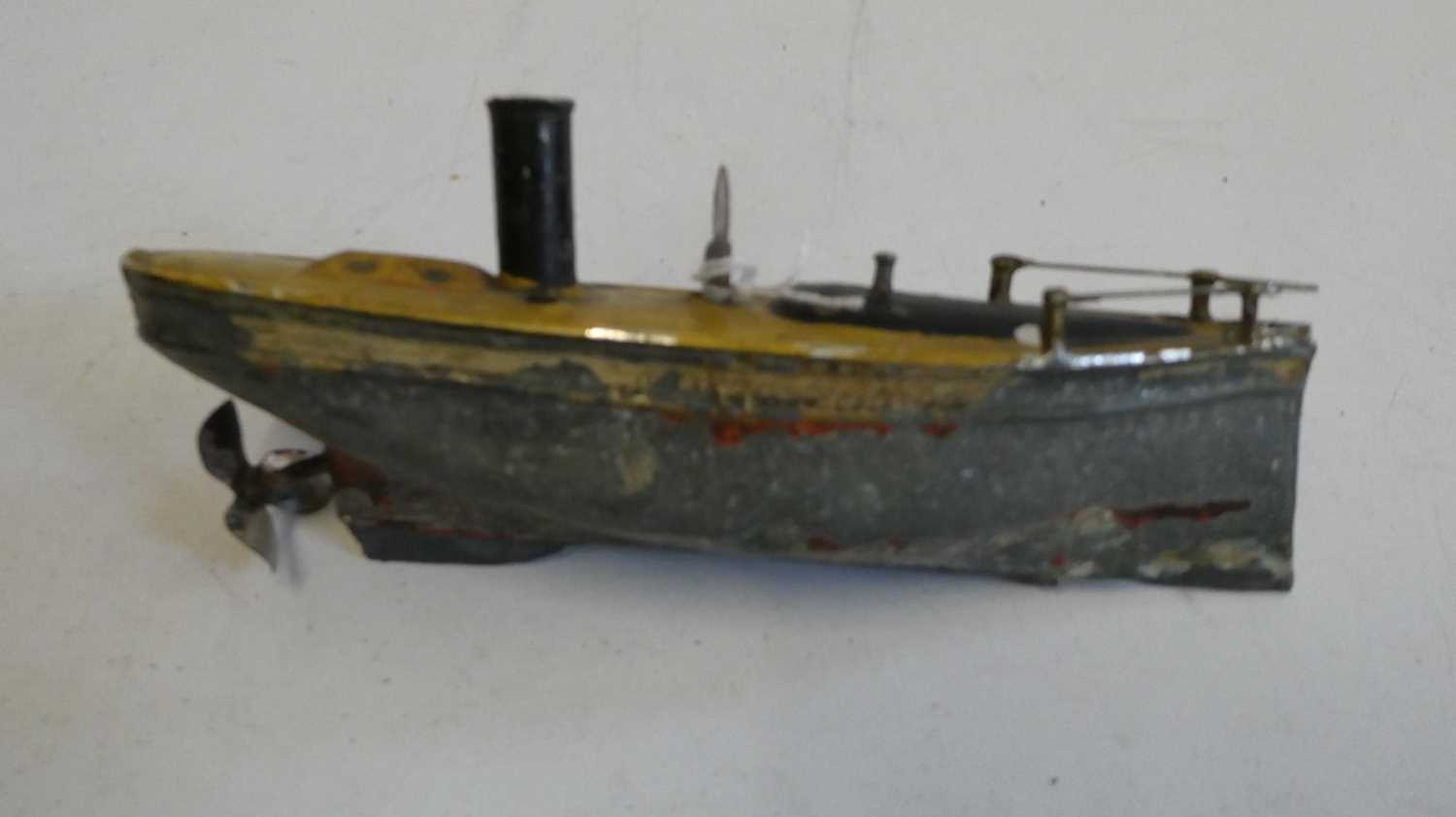 Small Carette clockwork steamboat, motor tested working, rudder, flagpole and boat stand missing,