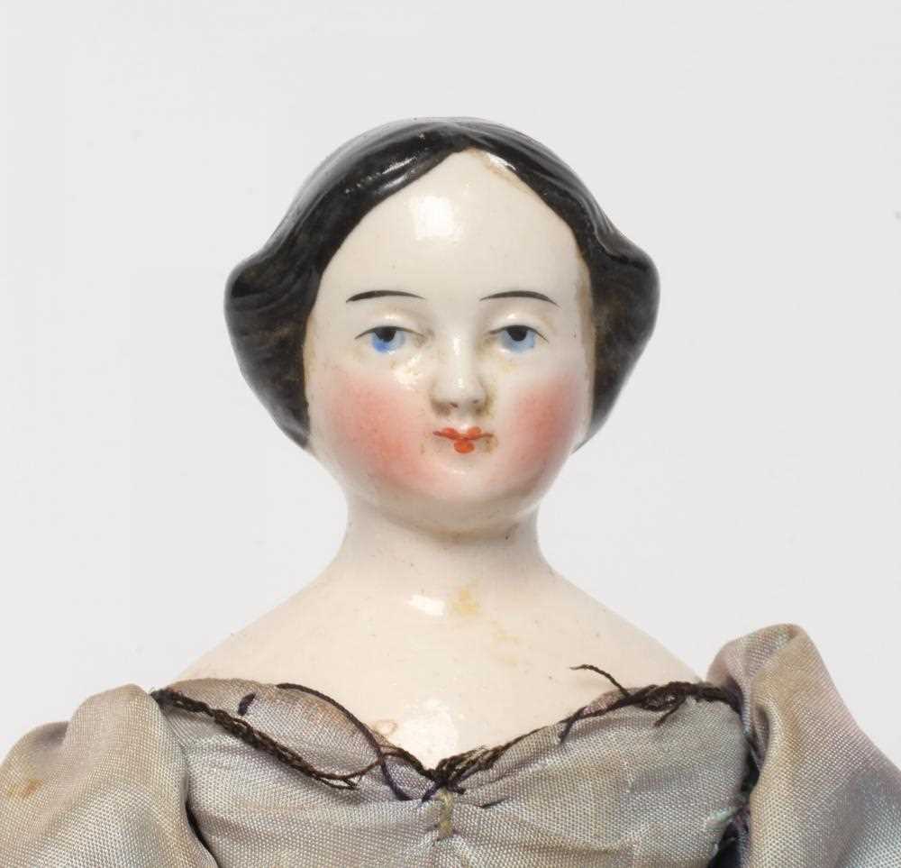 A china shoulder head doll, c.1880, with moulded hair, painted features, fabric body, china lower - Image 2 of 3