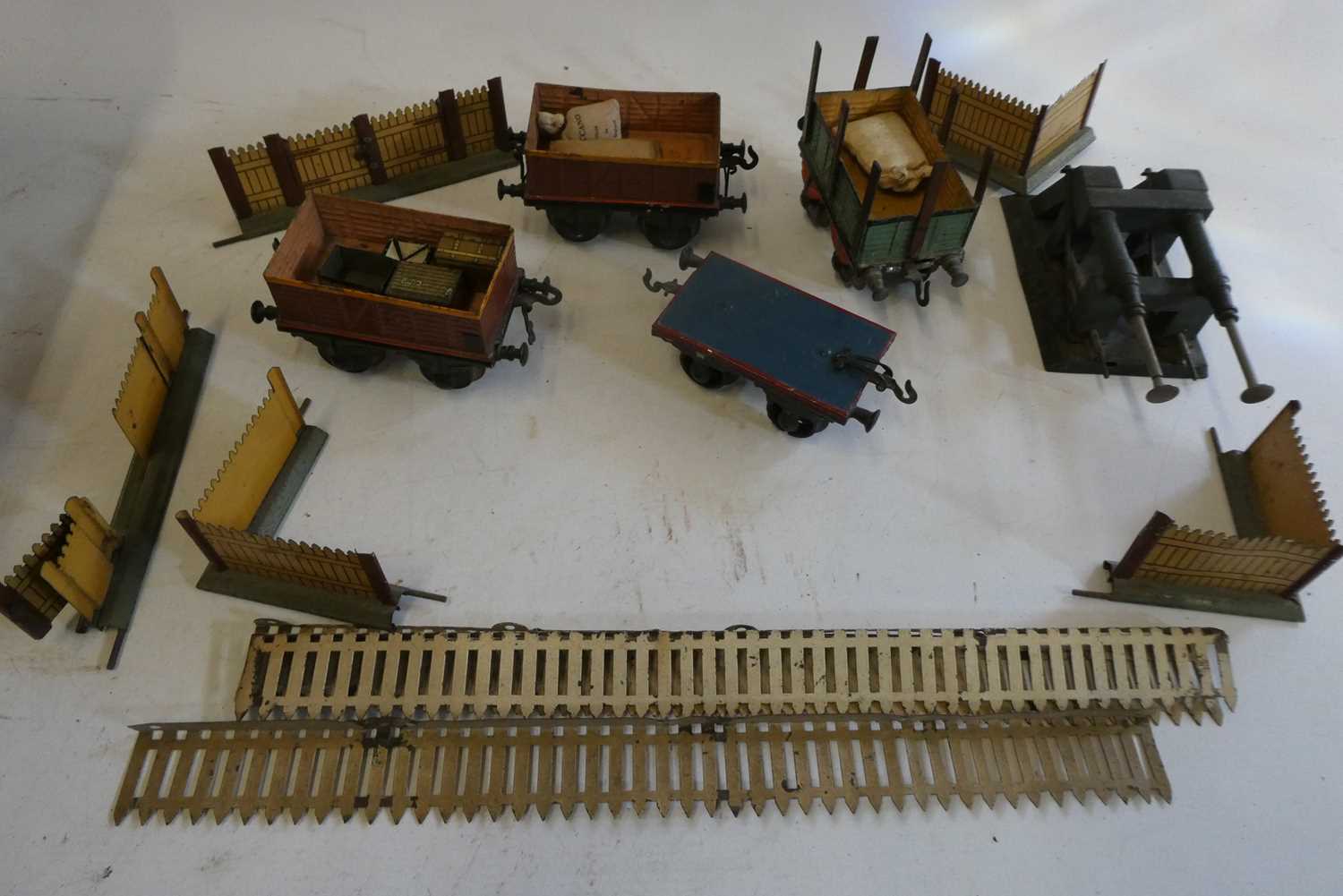 Four hand painted Gauge 1 goods wagons by Bing, lineside/station fencing and a gauge 2 buffer