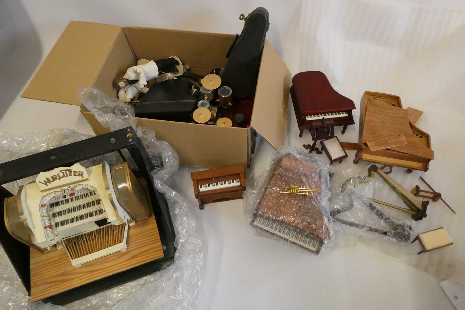 A large collection of doll's house musical room and associated items, including a model Wurlitzer