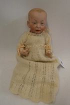 A Kammer & Reinhardt bisque socket head character doll, with painted features, bent limb composition