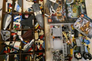 A large collection of Lego, including two unopened sets (Harry Potter 76382 and 76383), a built