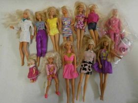 Twelve Barbie dolls, comprising ten Barbies, two younger sisters and a Barbie camera Condition