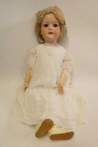 A Heubach Koppelsdorf bisque socket head doll, with blue glass sleeping eyes, open mouth, teeth,