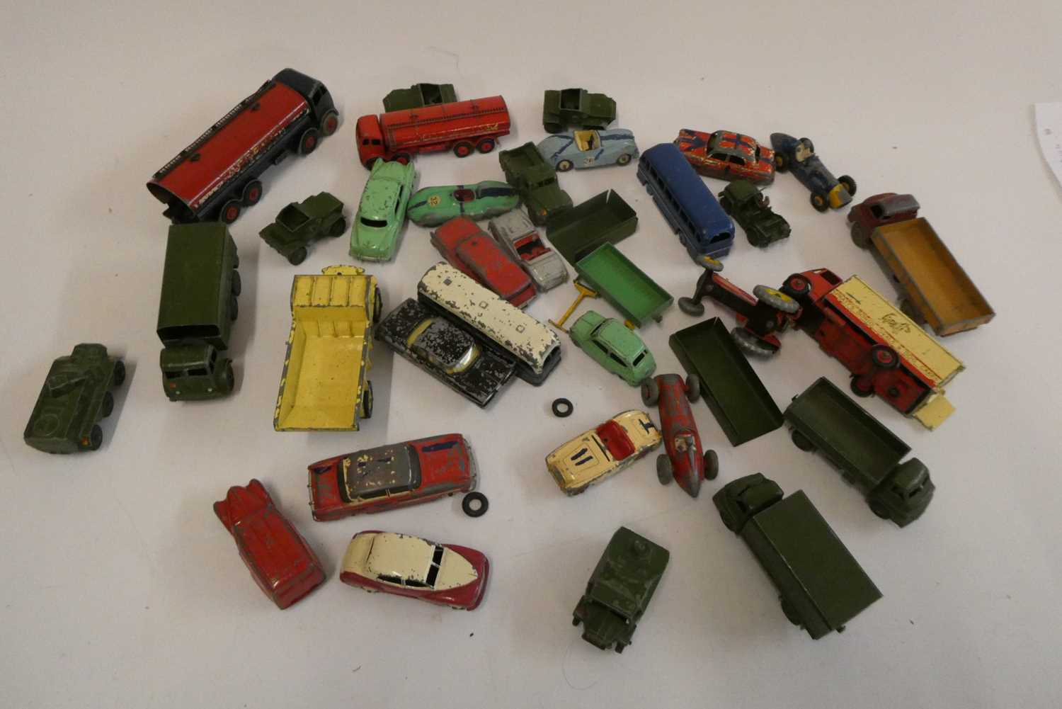 Playworn Dinky vehicles including cars, trucks, army vehicles and race cars, most items have paint