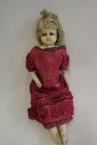 A Victorian wax shoulder head doll, with blue glass eyes, blond hair, closed mouth, kid body and