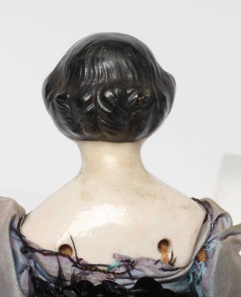 A china shoulder head doll, c.1880, with moulded hair, painted features, fabric body, china lower - Image 3 of 3