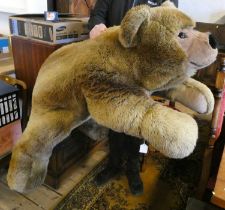 A very large Steiff recumbent teddy bear, with long brown plush, brown eyes, short plush nose and