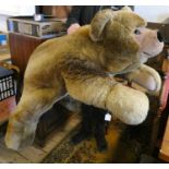 A very large Steiff recumbent teddy bear, with long brown plush, brown eyes, short plush nose and