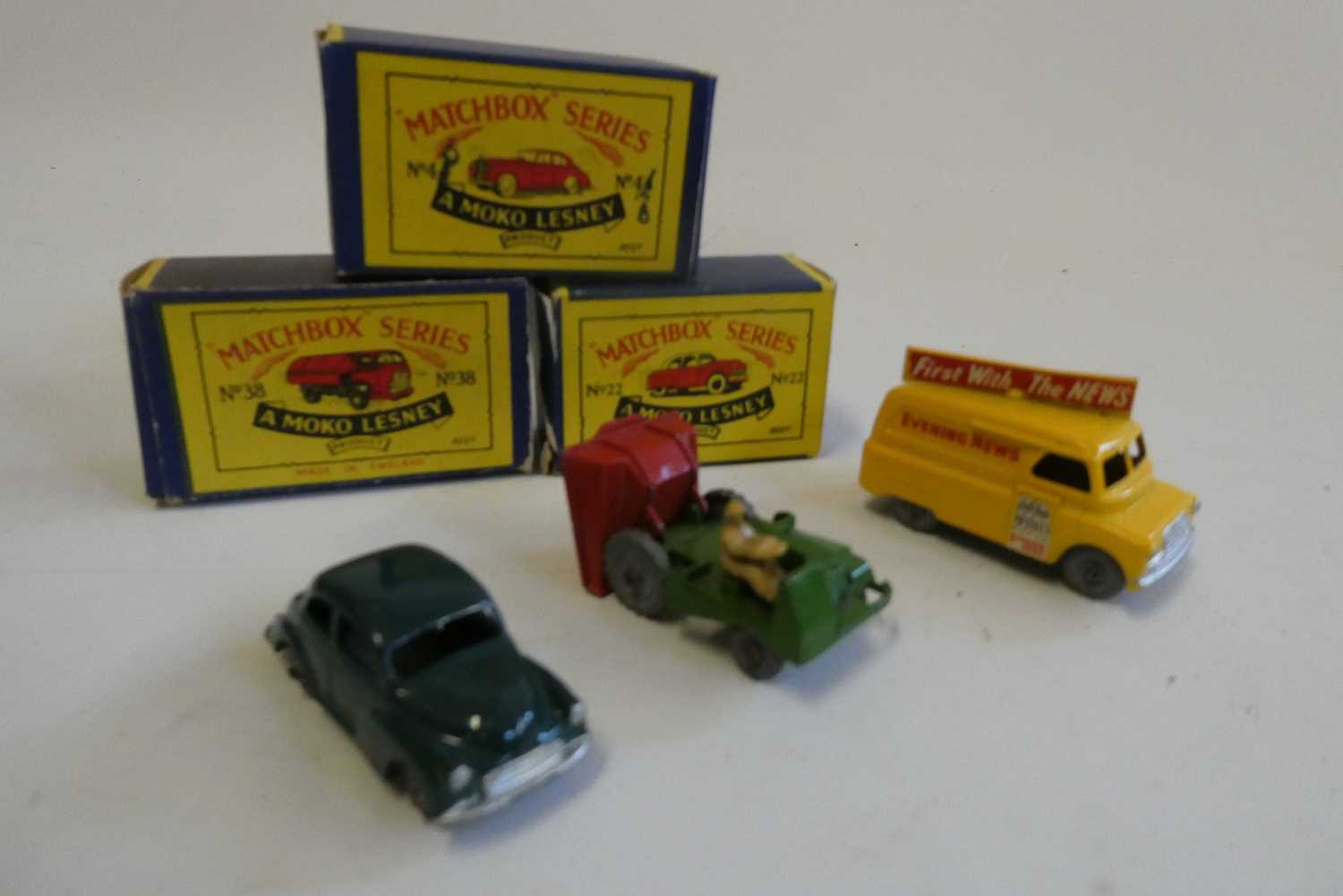 Three unboxed Matchbox vehicles comprising Yellow Bedford News van, dark green Morris Minor and Site