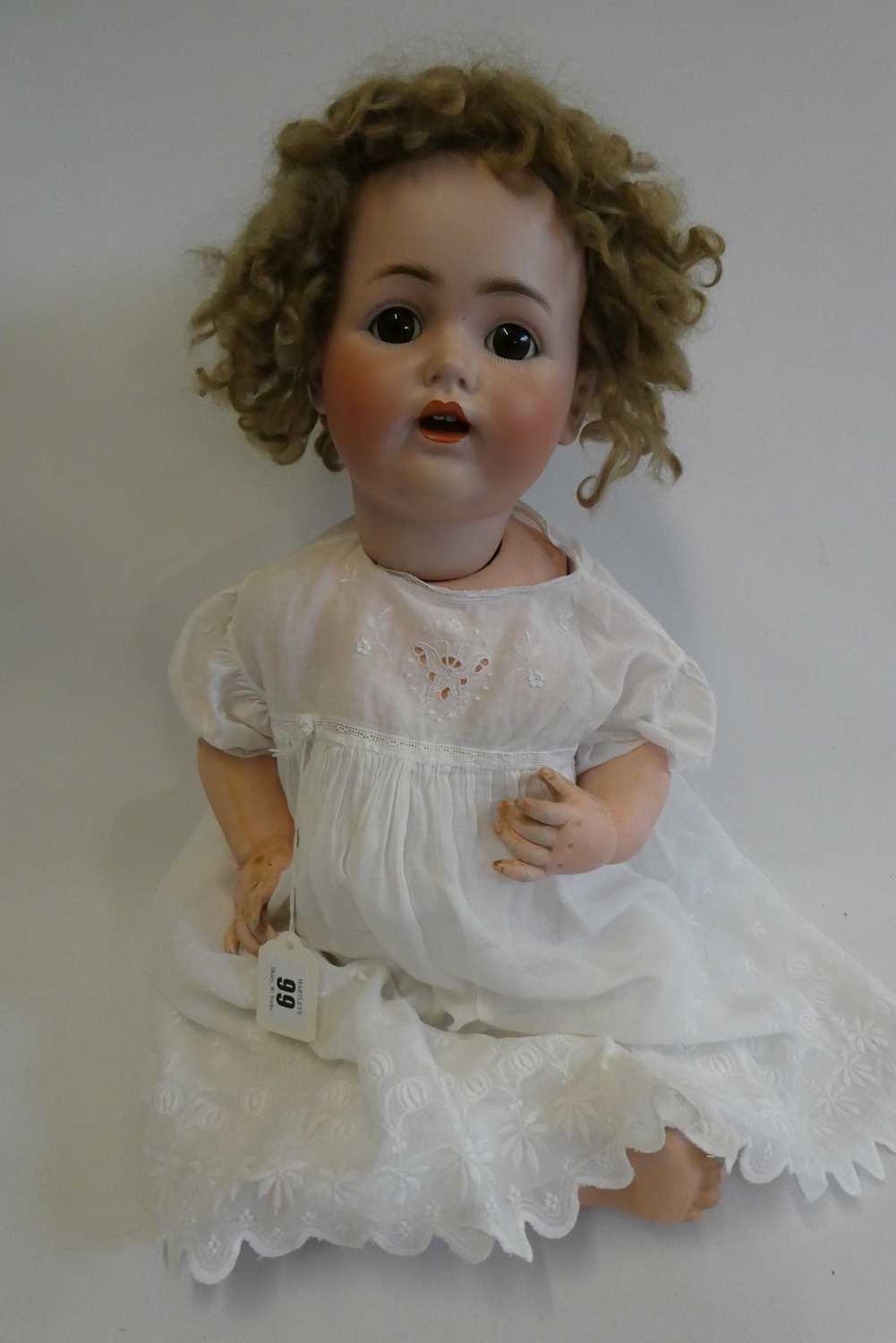 A J.D. Kestner bisque socket head character doll, with brown glass sleeping eyes, open mouth,