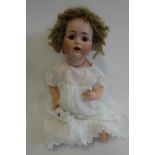 A J.D. Kestner bisque socket head character doll, with brown glass sleeping eyes, open mouth,