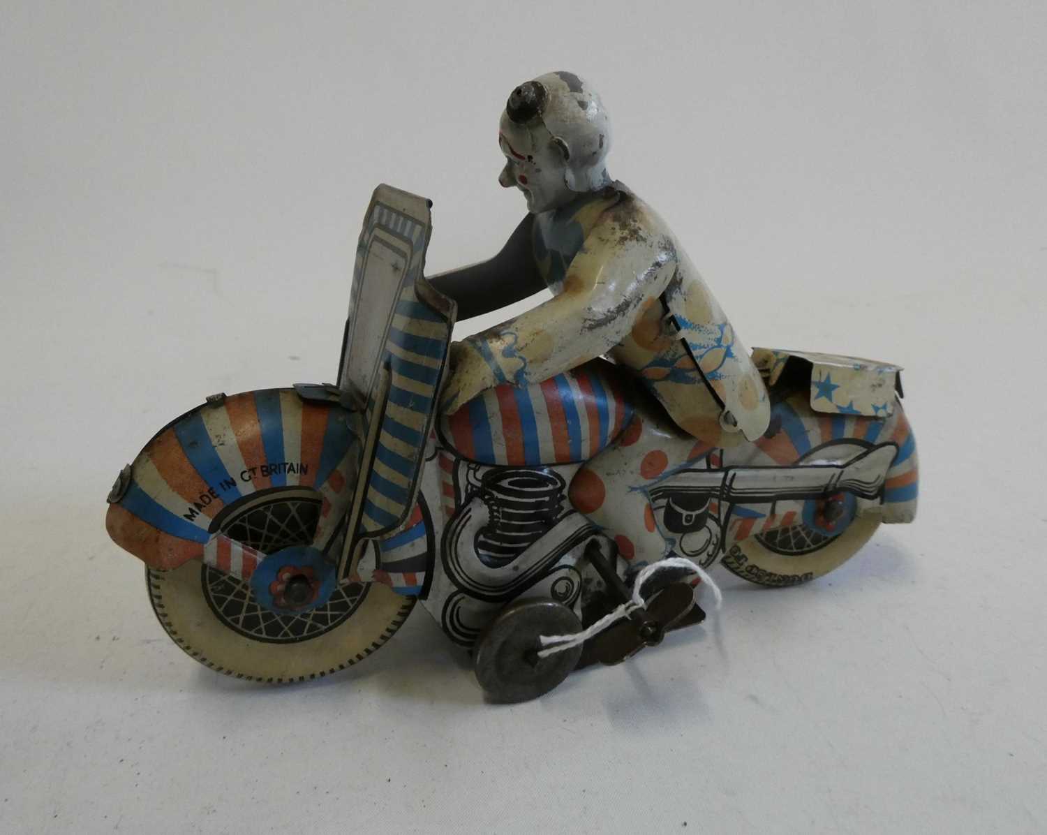 Mettoy clockwork clown motorcycle, tinplate finish has sunlight fading and some minor damage,