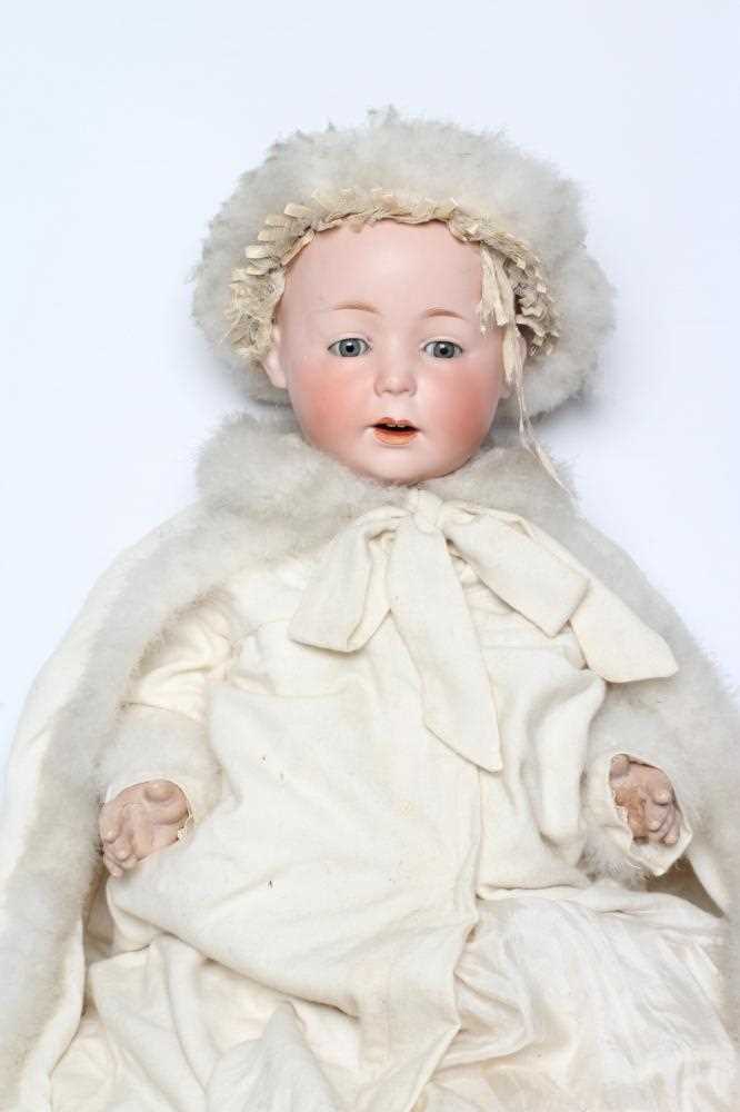 A German bisque head boy character doll, possibly Gebruder Knoch, with blue glass sleeping eyes,