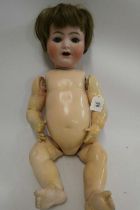 A Kammer & Reinhardt bisque socket head character doll, with blue glass sleeping eyes, open mouth,