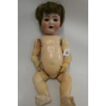 A Kammer & Reinhardt bisque socket head character doll, with blue glass sleeping eyes, open mouth,